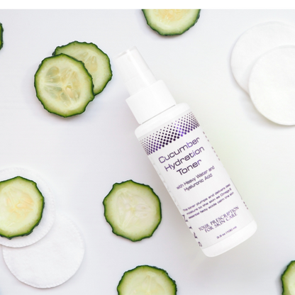 bottle of the skin script cucumber hydration toner 3.3 oz with slices of cucumber and cotton pads. 