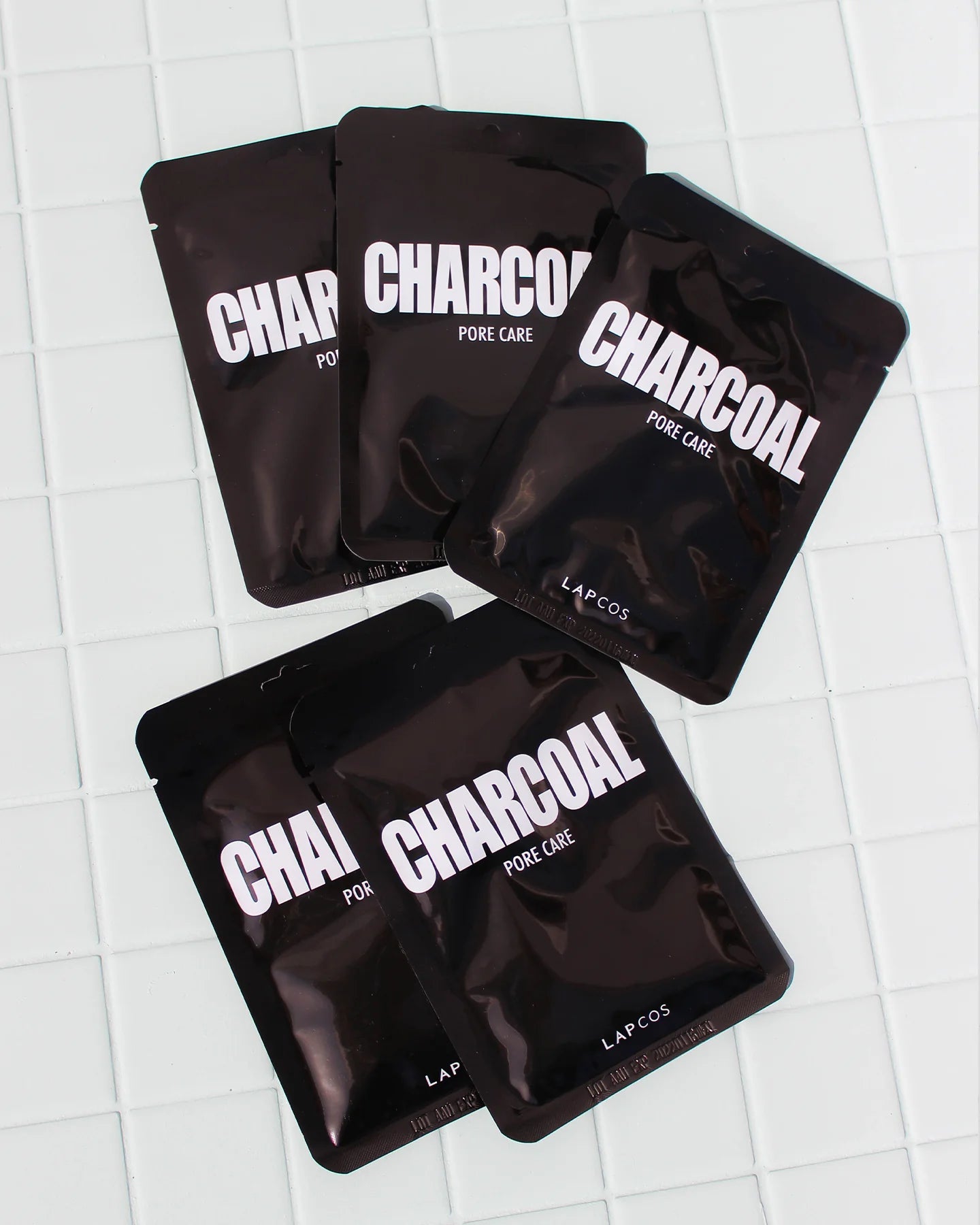 the 5-pack lapcos charcoal sheet mask on white tile sold at heaven on earth