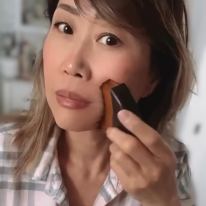 image of woman using the small lymphatic brush by cecily braden to stimulate her lymphatic fluids, detox, and sculpt her face.